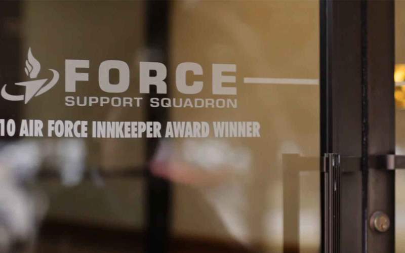 Glass door with Force Support Squadron and Air Force Innkeeper Award Winner text