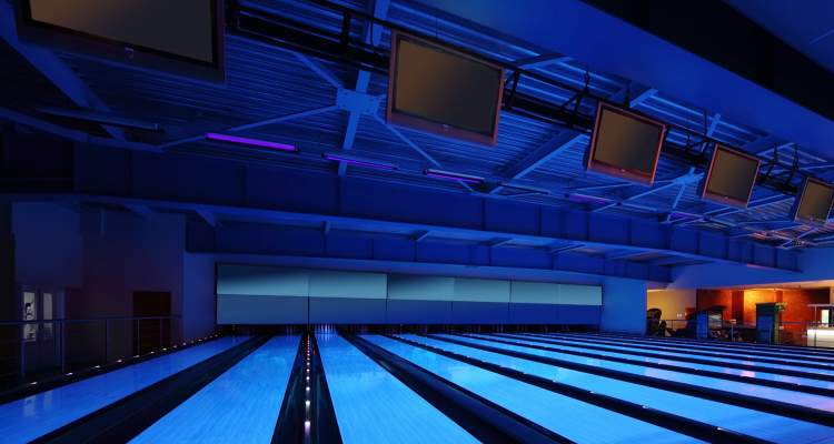 Bowling alley with overhead Smart TVs displaying synchronized content